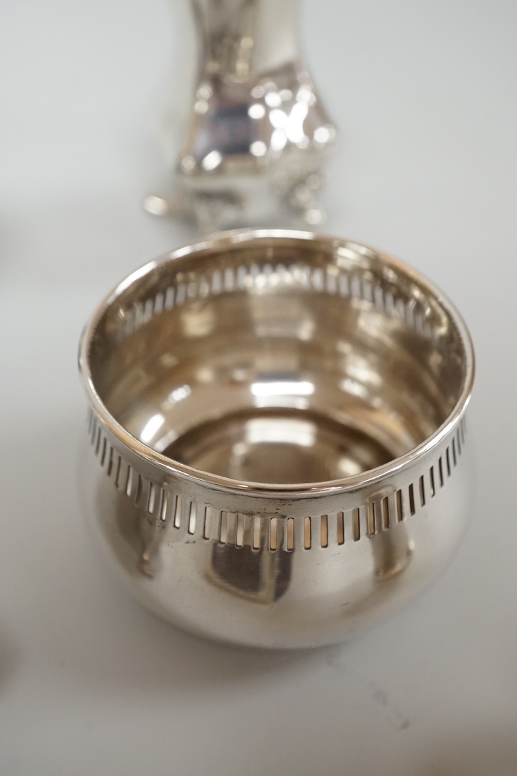 Four assorted silver condiments including a Victorian bun salt and a late Victorian pepper mill, together with a small silver bowl, a silver matchbox sleeve and a small silver two handled cup.